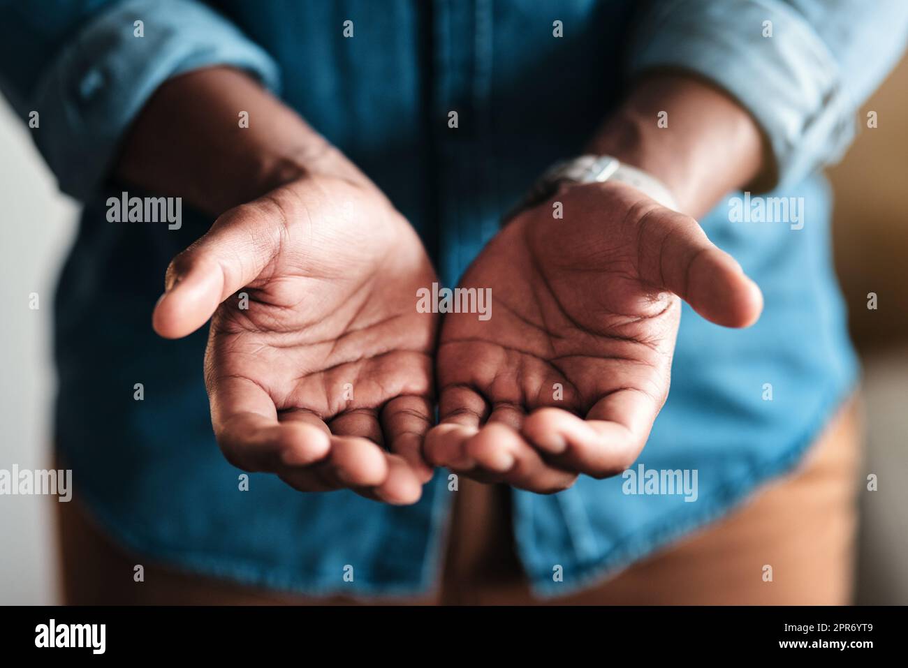 Place your trust in my hands. Cropped shot of an unrecognizable businessman standing in his home office and holding out his hands in a pleading gesture. Stock Photo