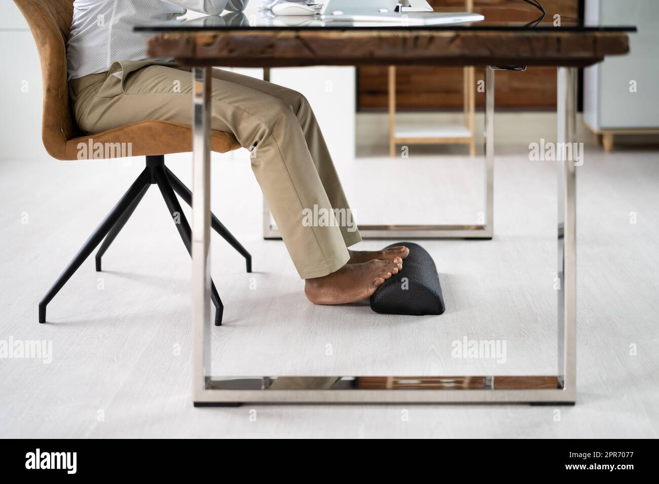 Footrest Against Pain In Office. Shifting Posture Stock Photo