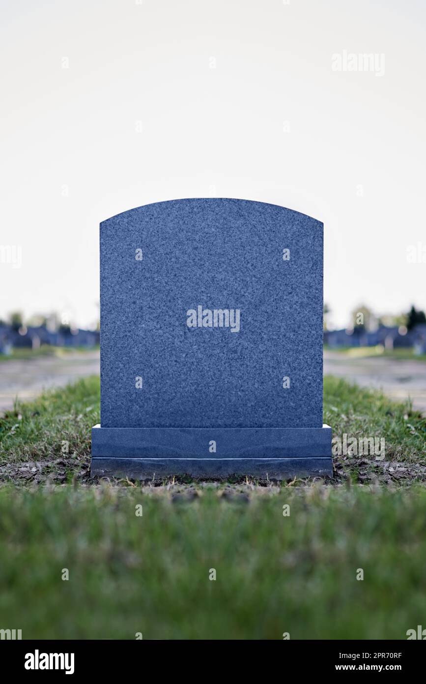 An eternal mark of their memory. Shot of a gravestone in a cemetery. Stock Photo