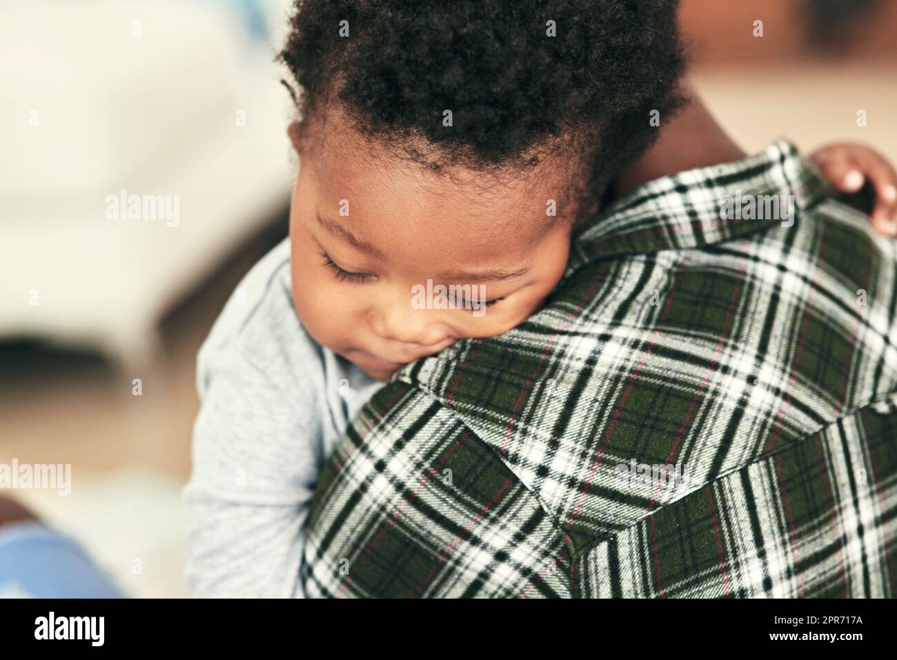 Sleep solves everything. Shot of an adorable baby boy falling asleep on his mothers shoulders. Stock Photo