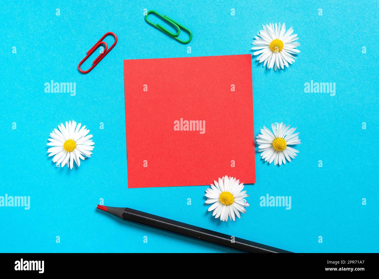 Sticky Note With Important Messages With Paperclips, Pencil And Flowers Around On Desk. Memo With Crutial Informations With Colored Clips Placed On Table. Stock Photo