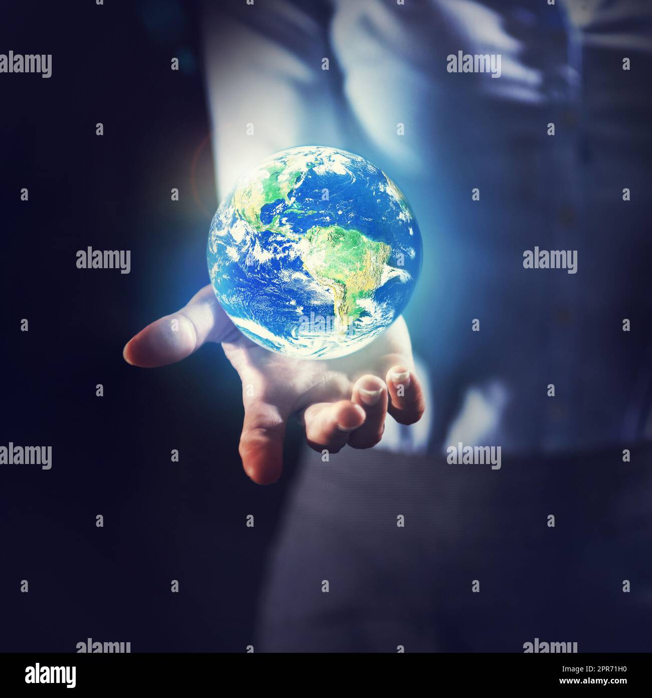 Preserving the earth. Shot of a businesswoman holding the earth in her palm. Stock Photo