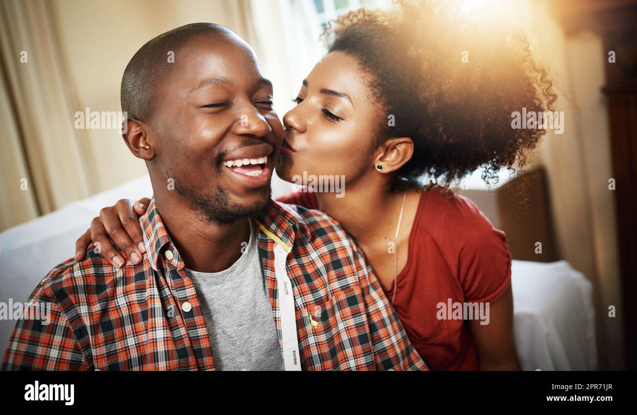 Showing some love. Cropped shot of an affectionate young couple enjoying the day at home. Stock Photo