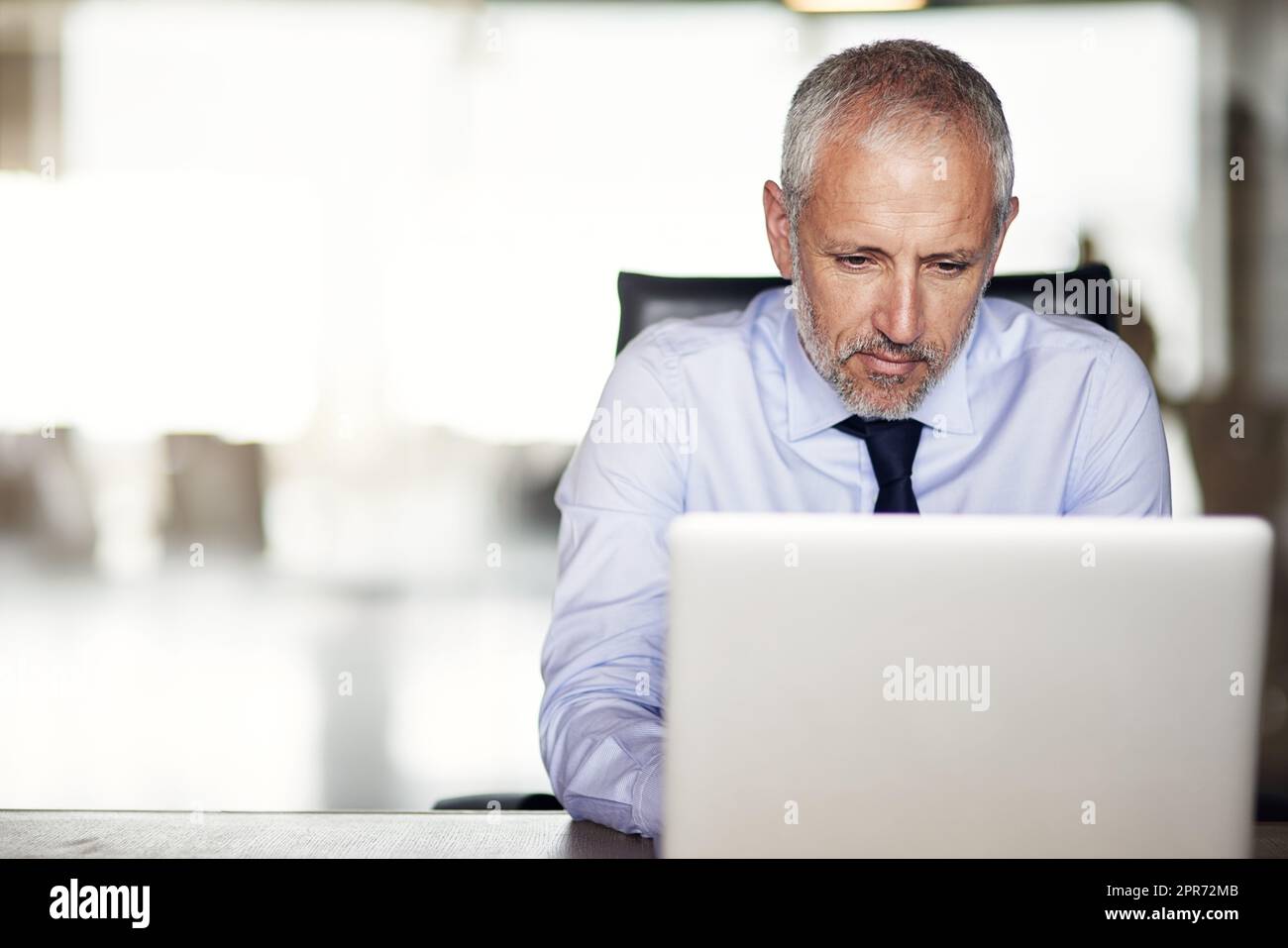 Building his business empire. Cropped shot of a mature businessman working in his office. Stock Photo