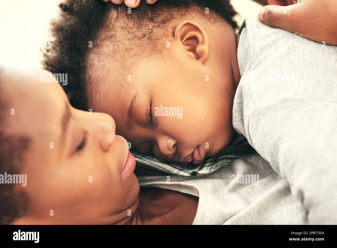 Hes growing up fast. Shot of a mother cradling her little baby boy. Stock Photo