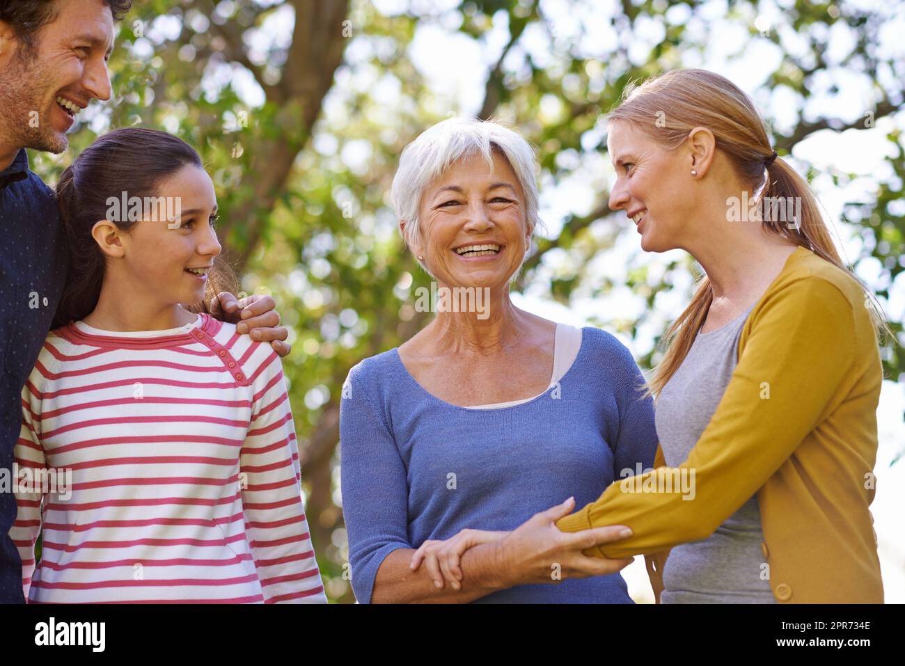 The family matriarch. Shot of a family standing together outside in the garden. Stock Photo