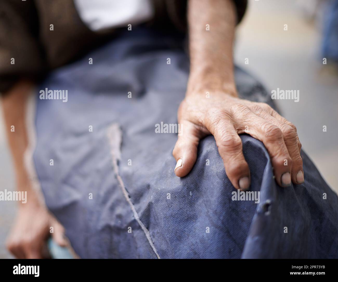 Getting old with dignity. Cropped shot of an elderly man wearing an apron. Stock Photo