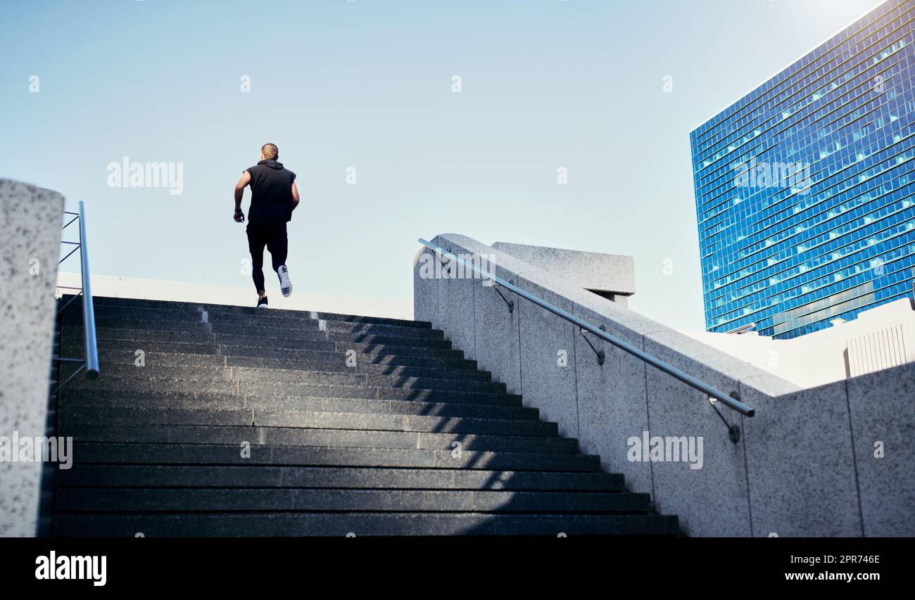 Every step is one step closer to your goal. Rearview shot of a young
