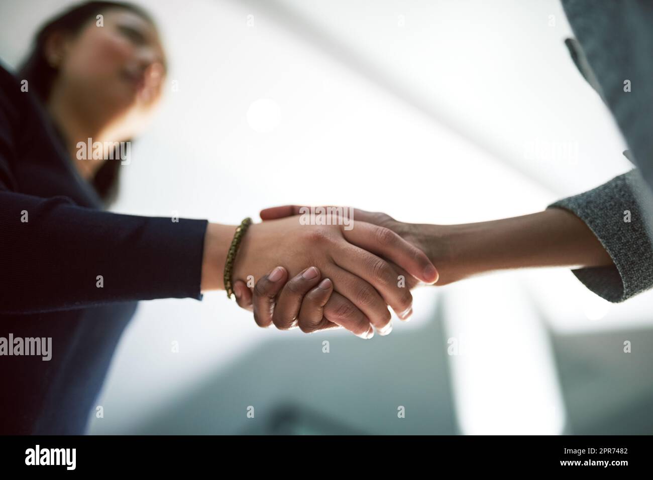 Shaking on their success. Cropped shot of two creative businesspeople shaking hands. Stock Photo