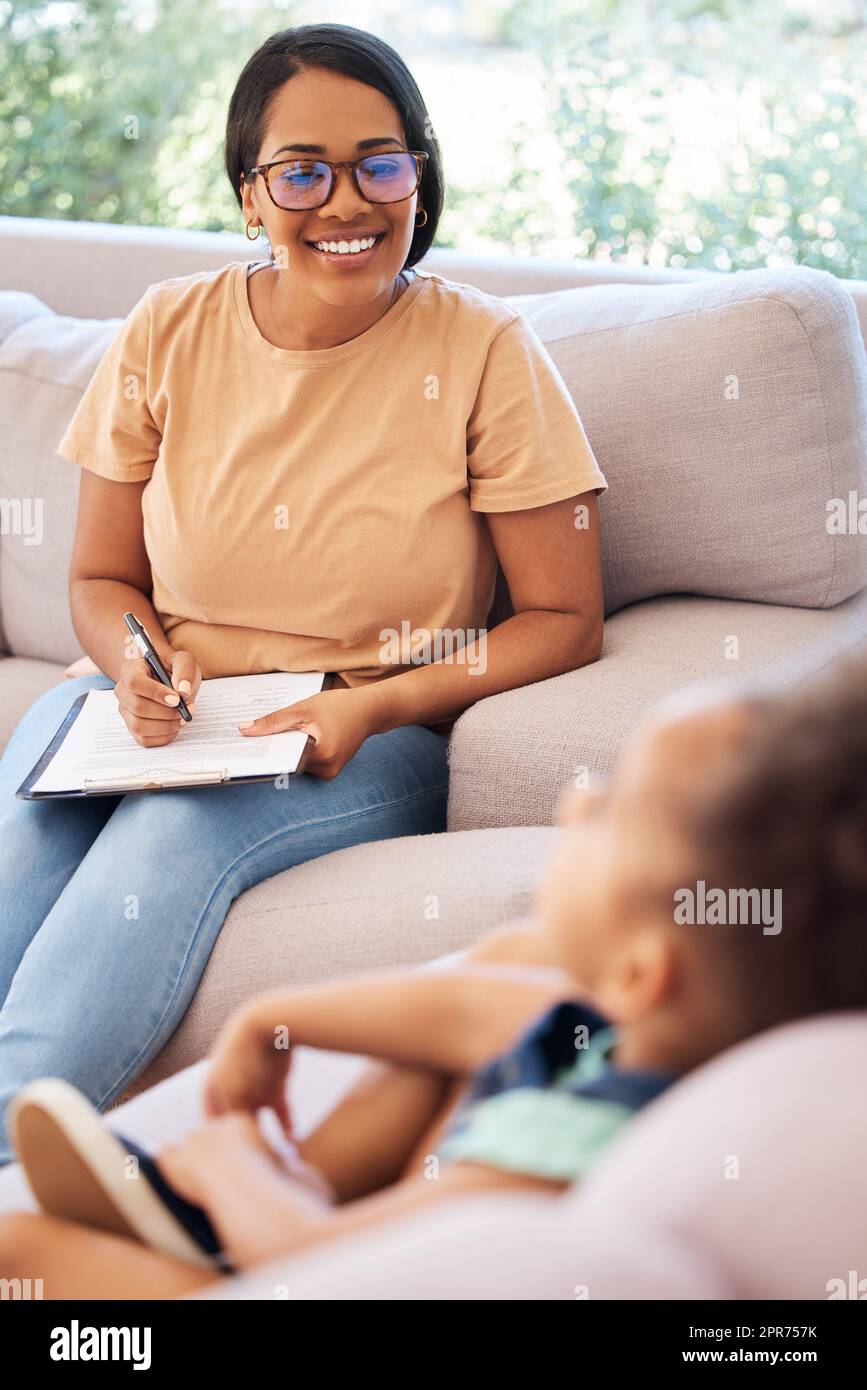 I love working with children. Shot of a psychiatrist talking to a little girl during a consultation. Stock Photo