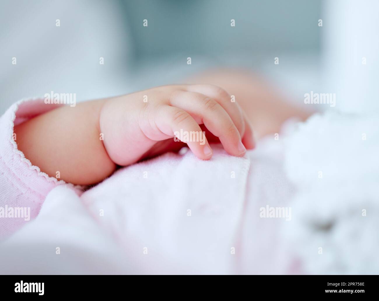 My littlest dream come true. Shot of a little babys hand while they sleep. Stock Photo
