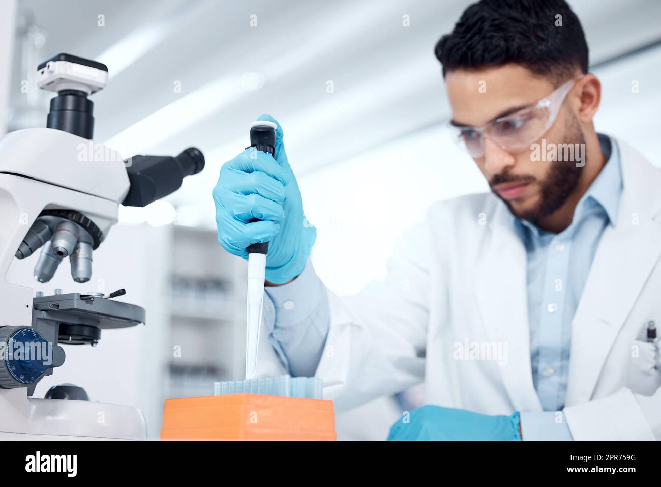 One mixed race male scientists wearing safety goggles and a labcoat