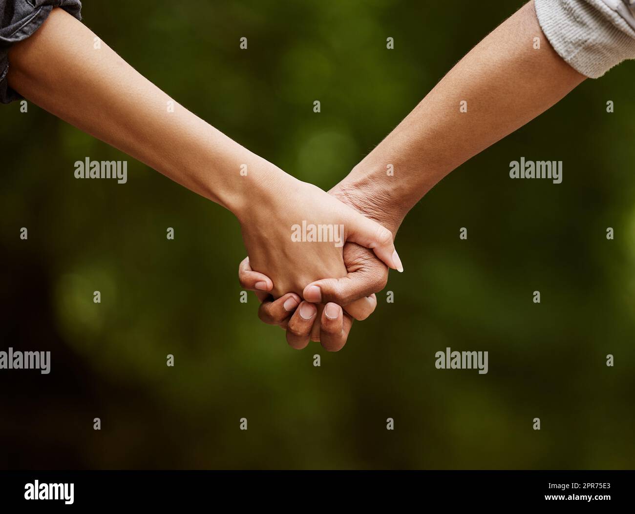 Walk with me through the wilderness. Closeup shot of an unrecognizable couple walking hand in hand through the wilderness. Stock Photo