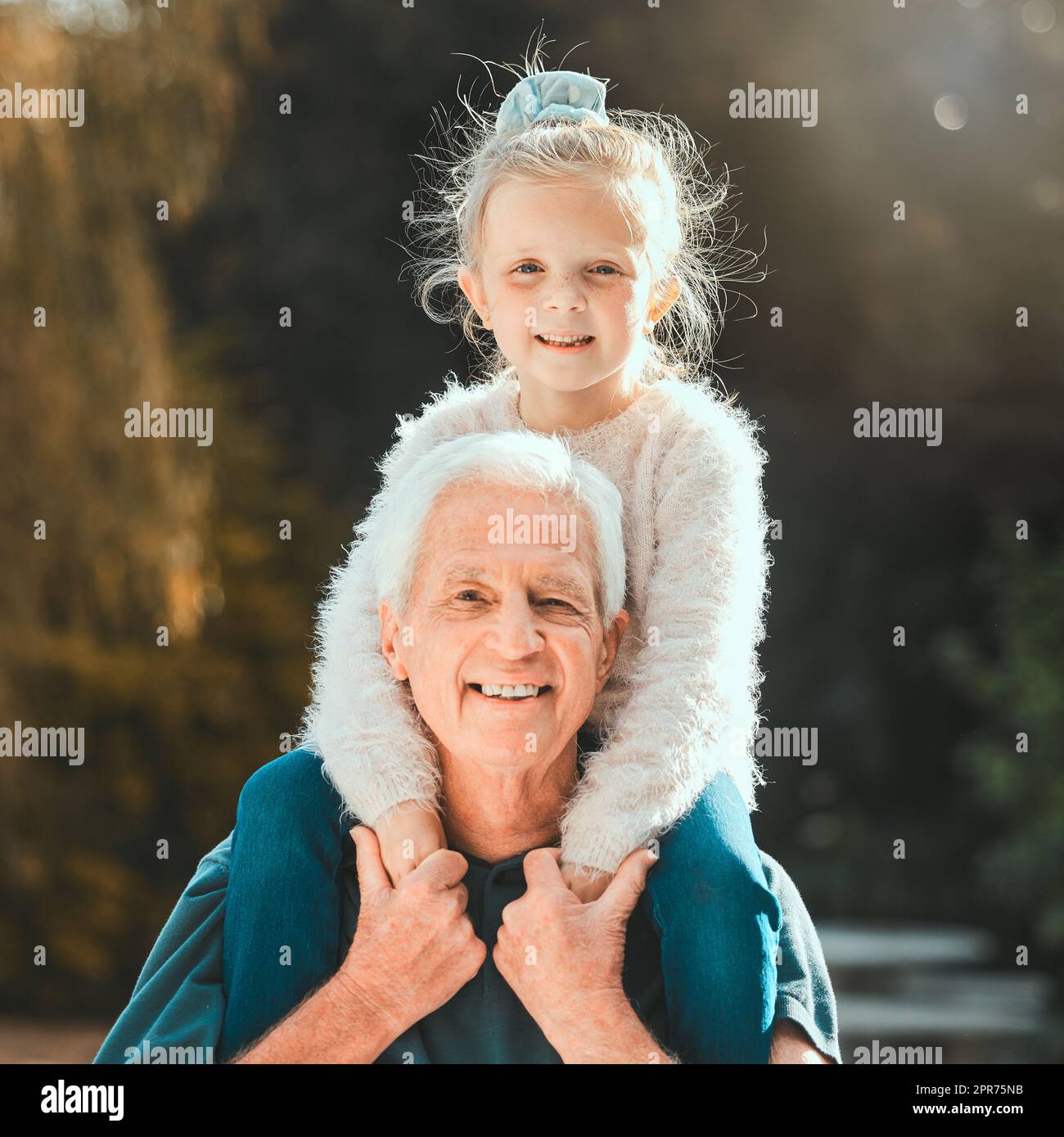What the daughter does, the grandfather did. Shot of a girl being carried by her grandfather outside. Stock Photo
