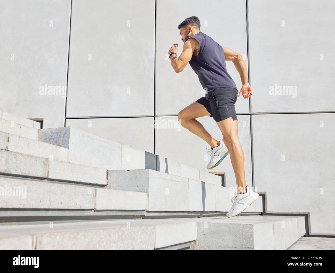 Head up and aim high. Low angle shot of a sporty young man running up a staircase while exercising outdoors. Stock Photo