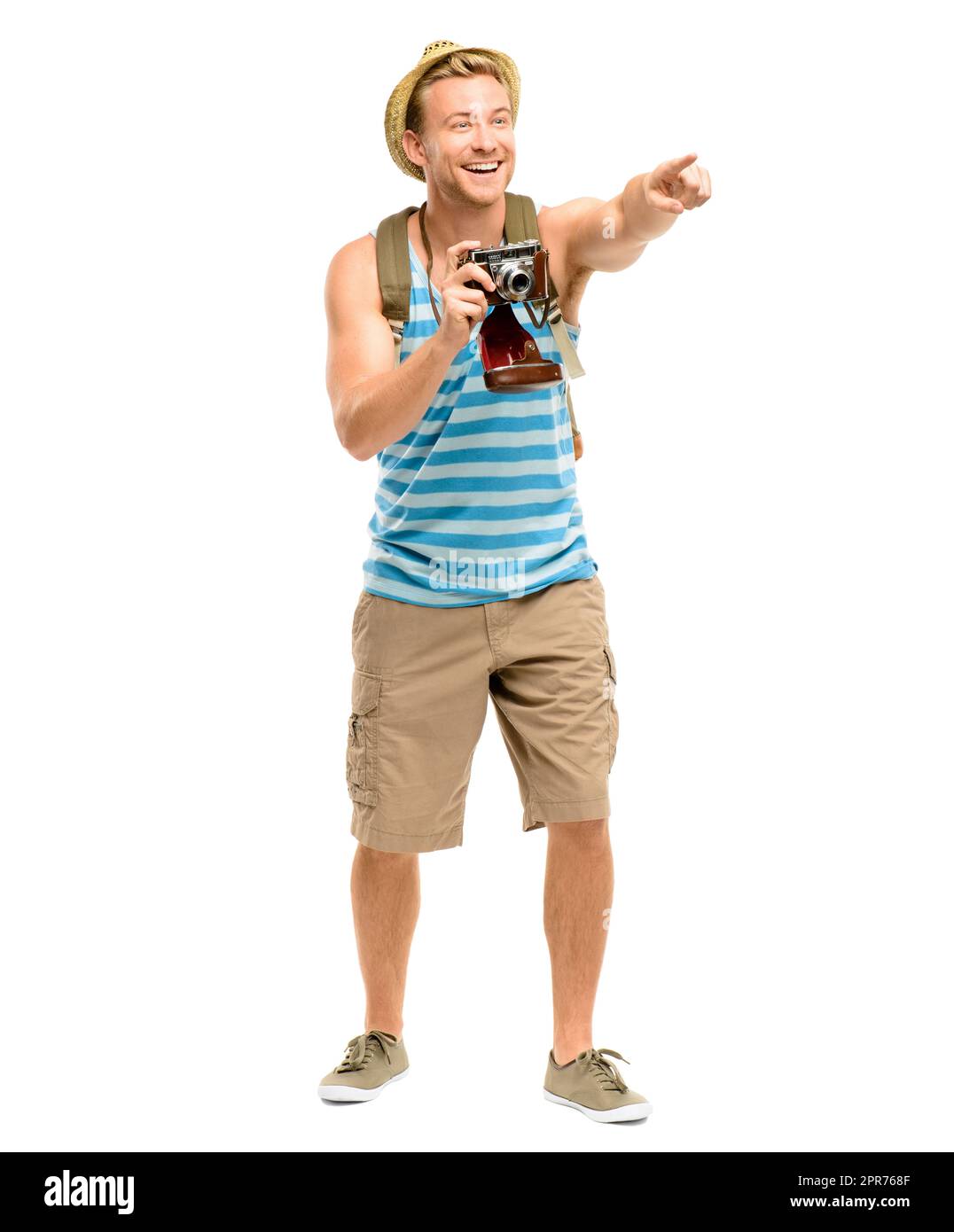 Wow, look at that. Full length shot of a handsome young tourist standing alone in the studio and pointing before taking a photograph. Stock Photo