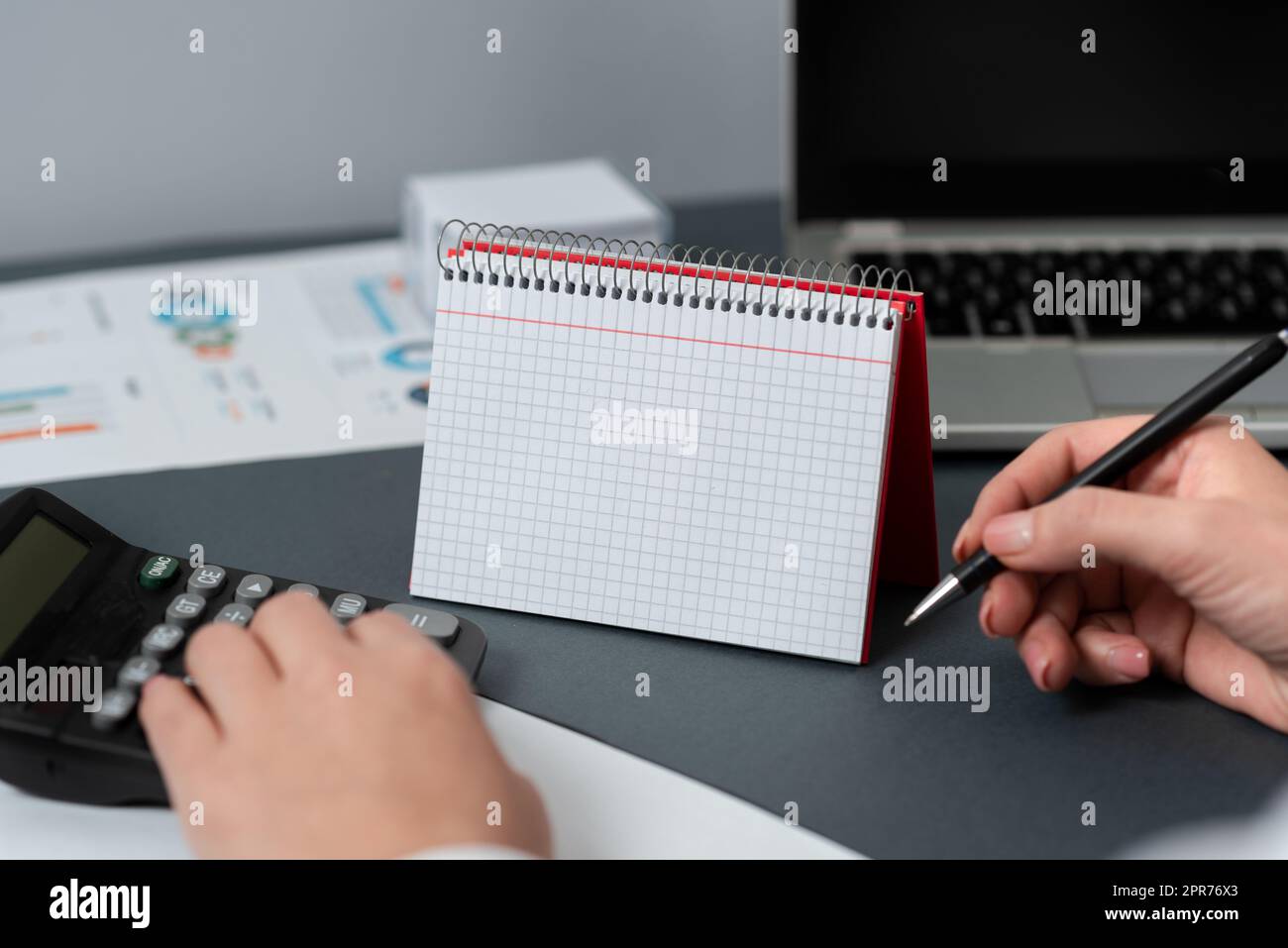 Businesswoman Holding Pen And Pointing On Desk With Notebook With New ...