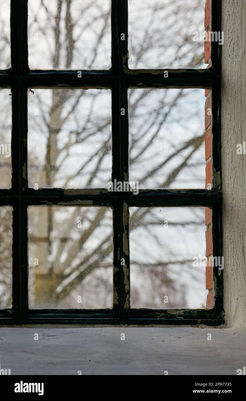 Closeup of an old window. Feeling trapped, scared, depressed and lonely during lockdown. Hiding inside at home, suffering from social anxiety, longing and looking to escape house for change and hope Stock Photo