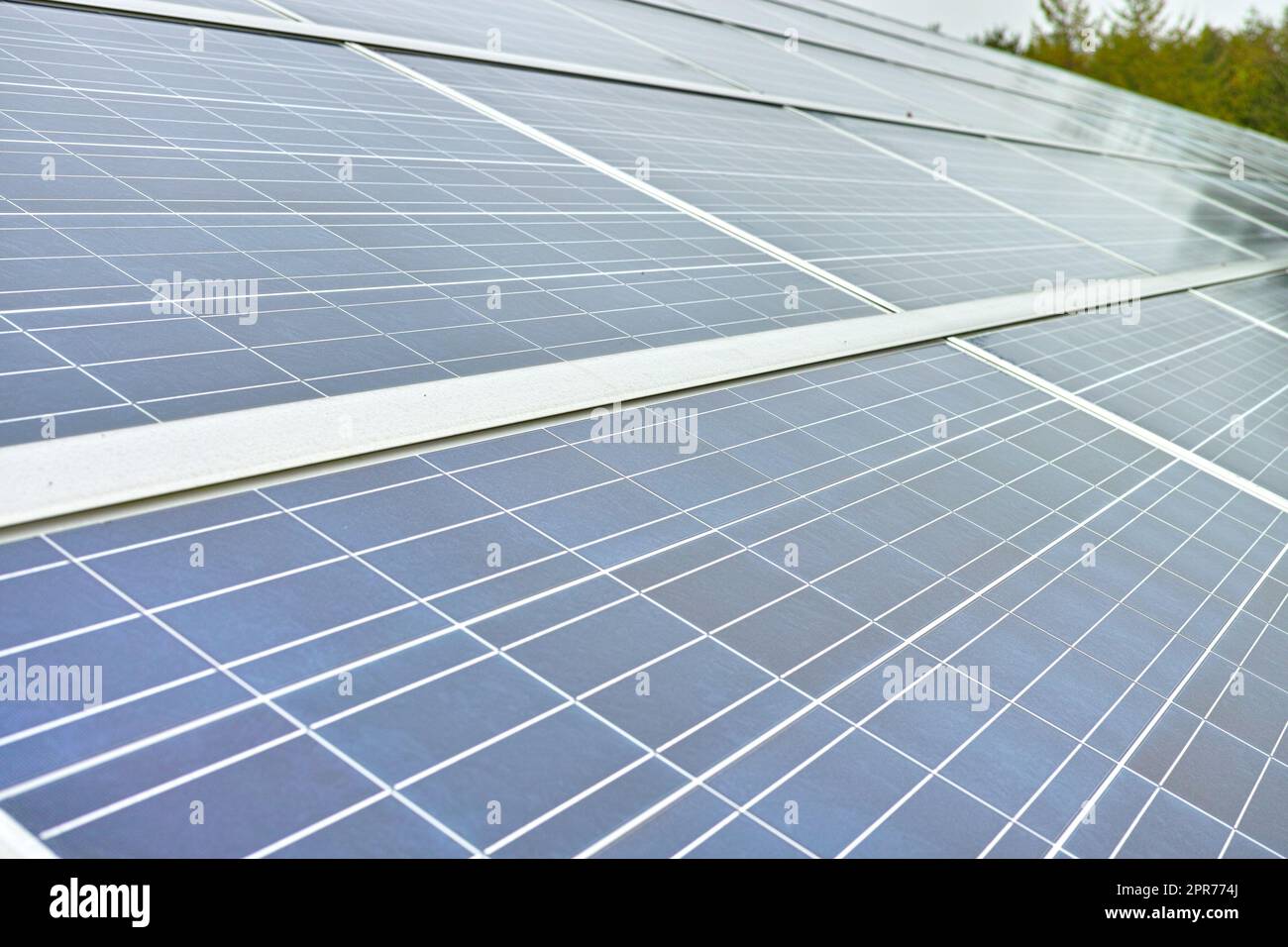 Solar power installation cell panels are a renewable sustainable energy source. Blue solar panels in Denmark. Photovoltaic generating electricity in electric stations, alternative energy from nature Stock Photo