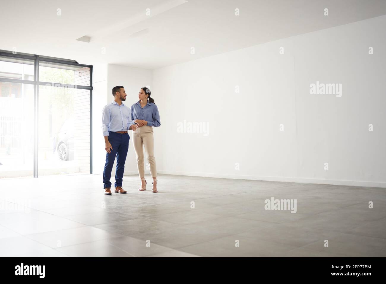 Welcome Home Its the perfect place for you. Shot of a young male real estate agent showing a client a house. Stock Photo