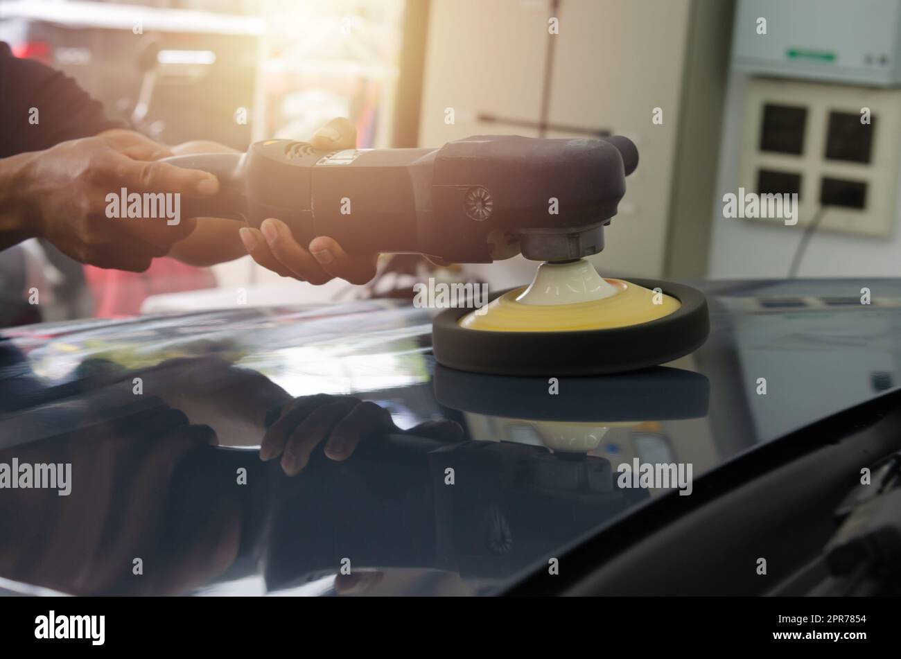 Man holding tool polish mechanic auto repair detailing hood car scratch