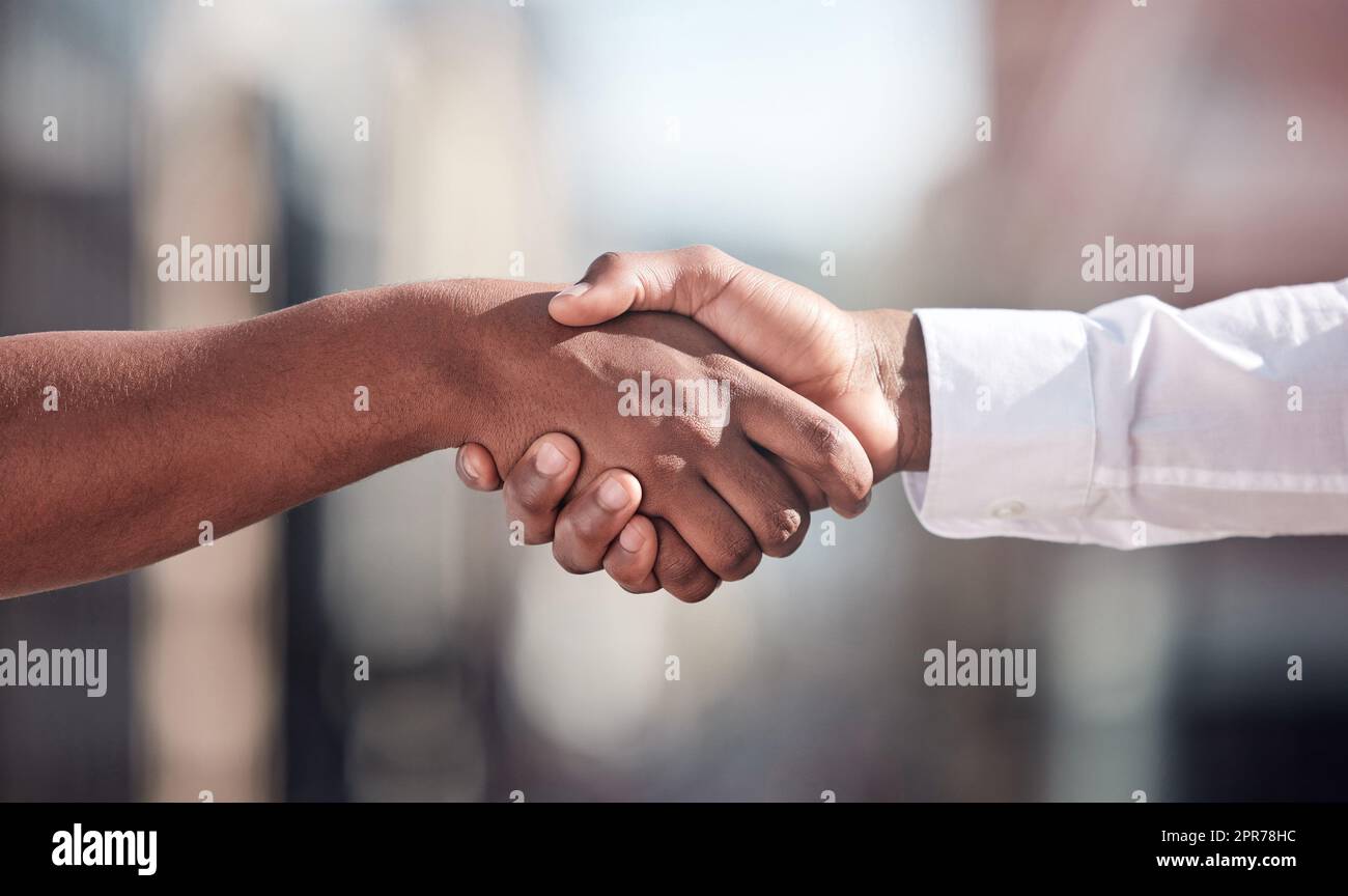 Lets collaborate. Cropped shot of two unrecognizable businessmen shaking hands outside. Stock Photo
