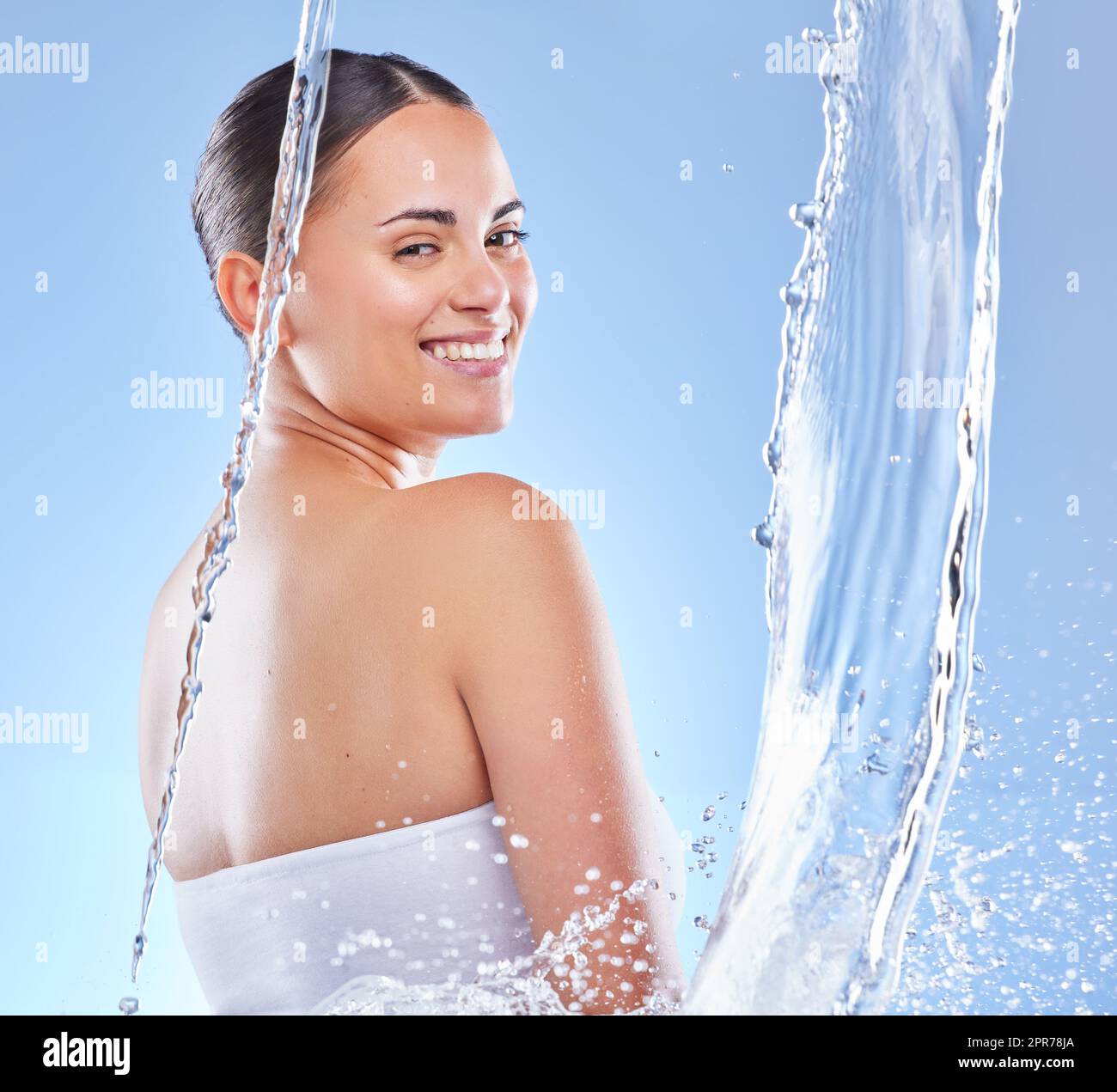 Water babe. Shot of a beautiful young woman enjoying a refreshing