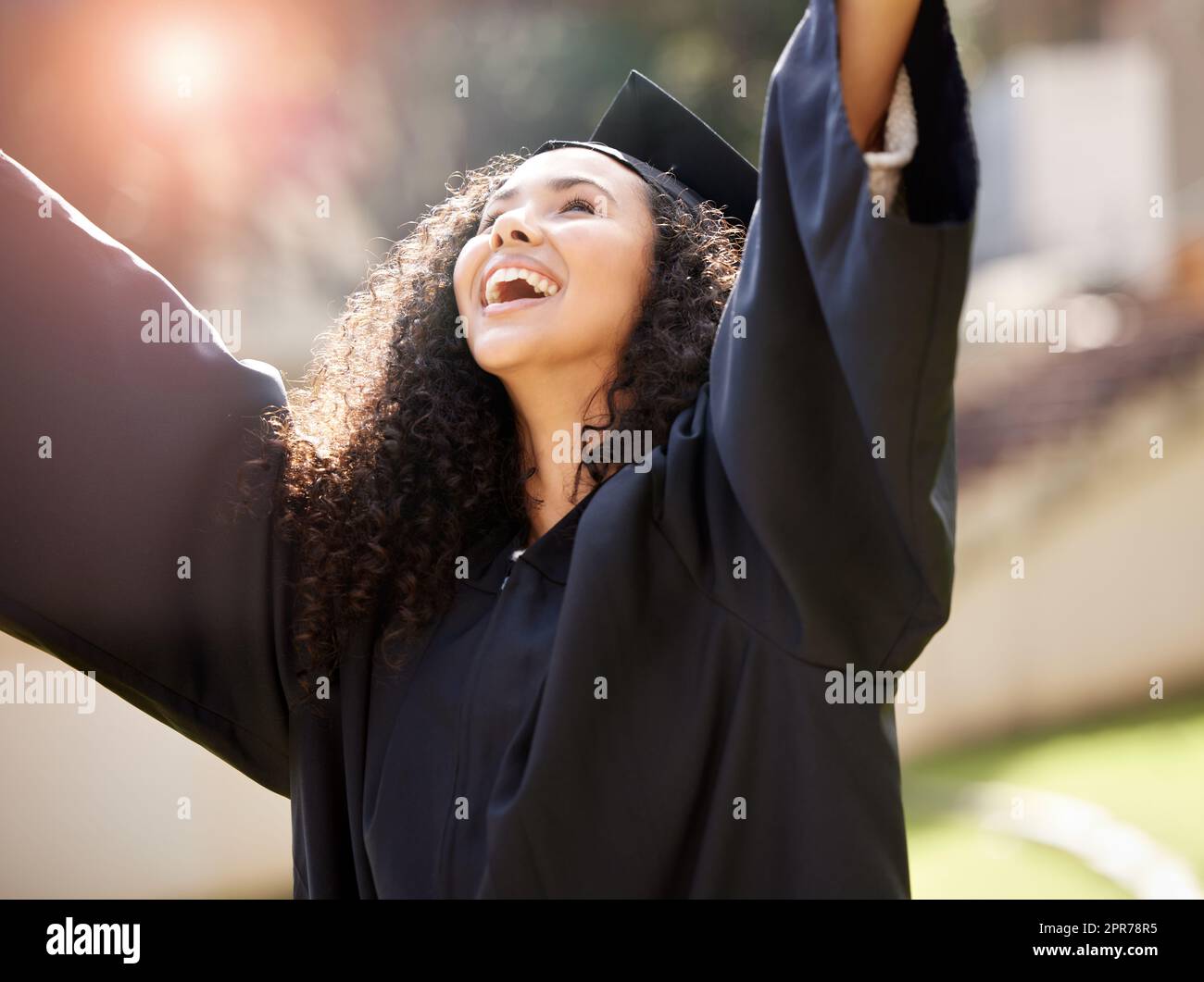 Im going to achieve all my hopes for the future. Shot of a young woman cheering on graduation day. Stock Photo