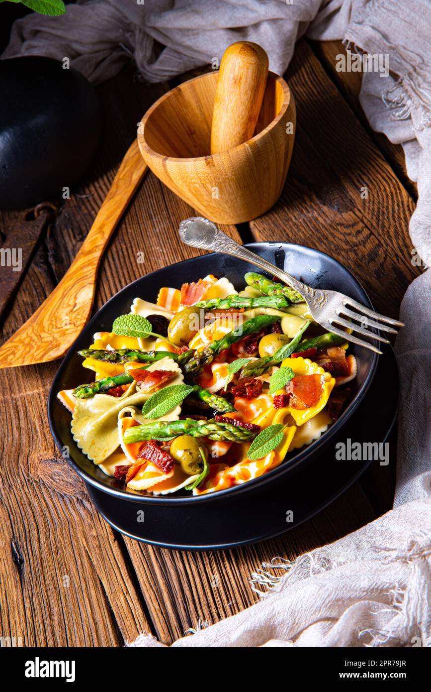 Pasta salad with green asparagus, olives and parma ham Stock Photo Alamy