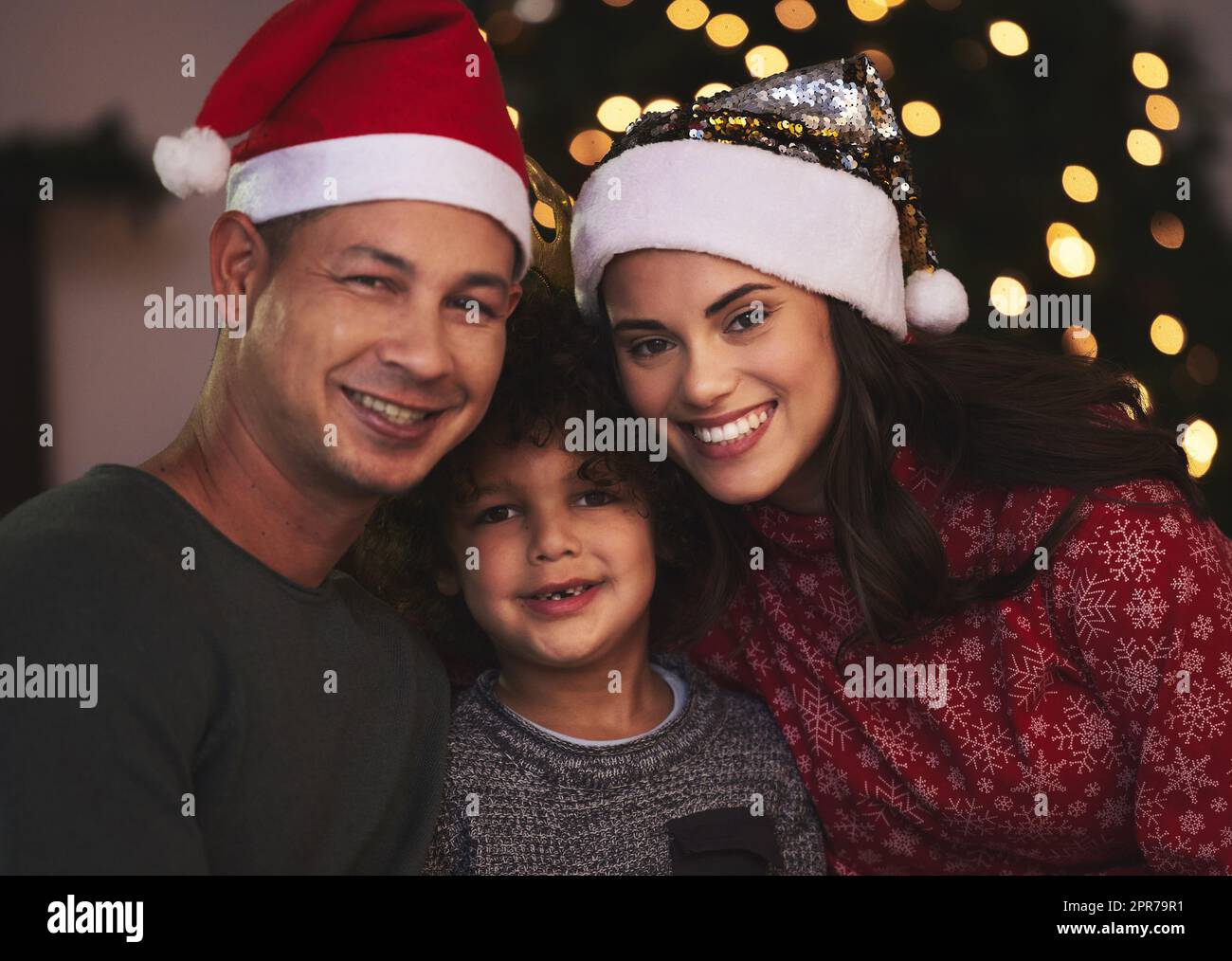 Were in the Christmas spirit. a young family celebrating Christmas at home. Stock Photo