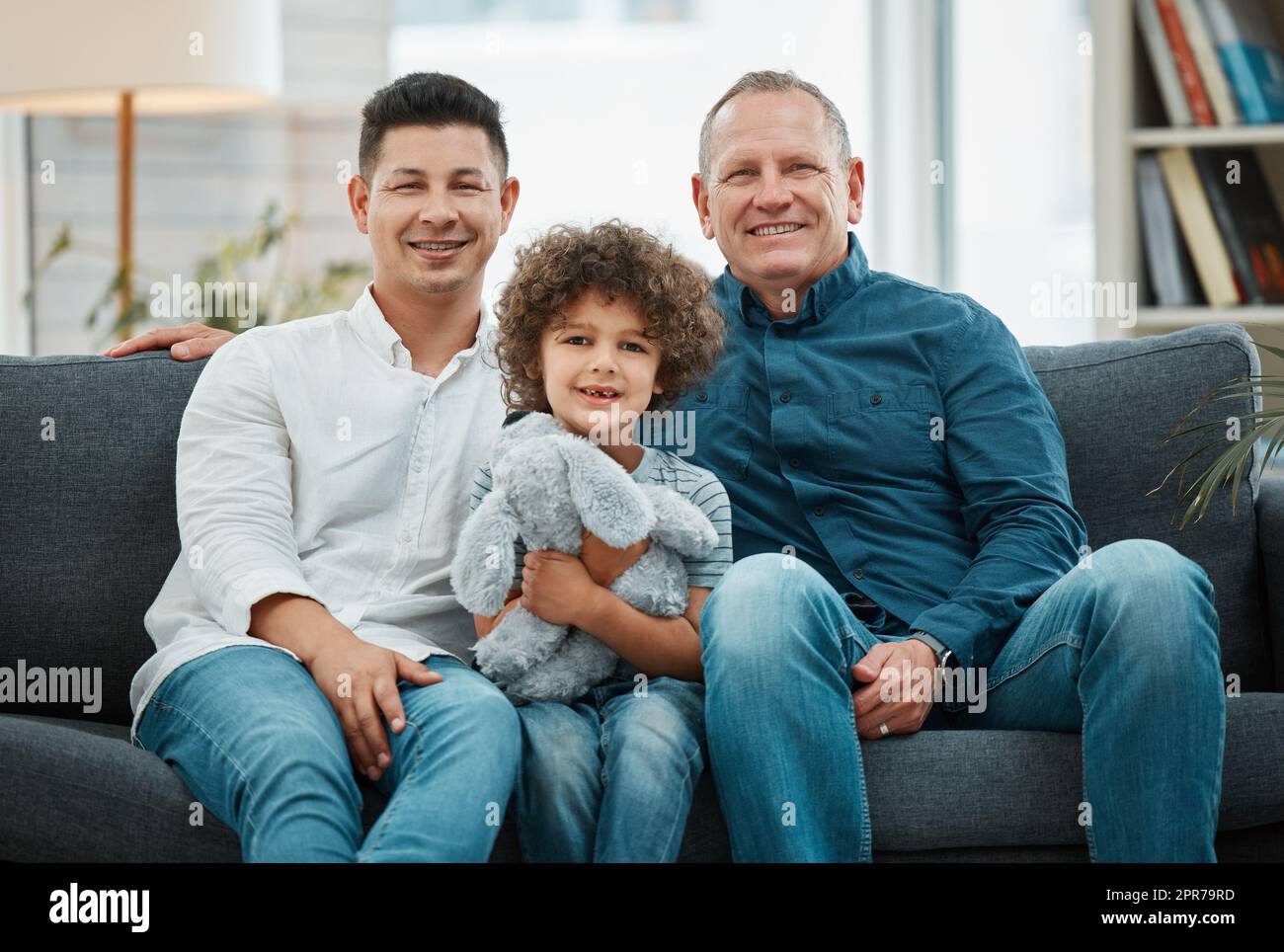 Two generations of strong men. a young man and his father spending time with his son. Stock Photo