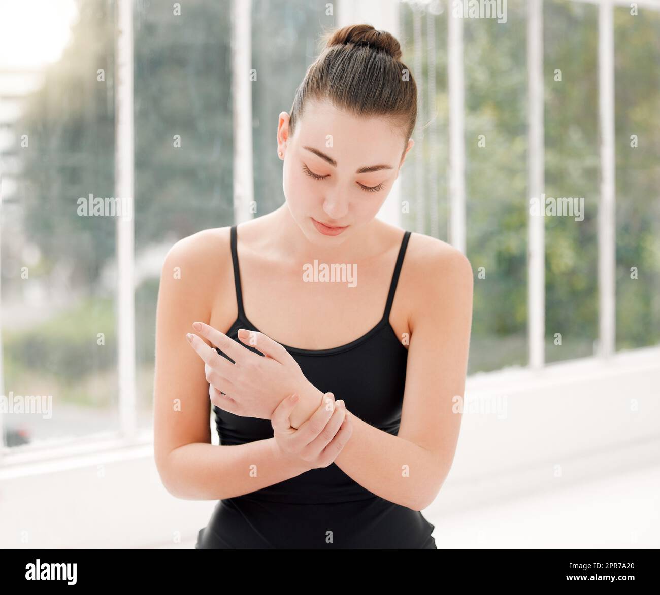 a ballet dancer experiencing wrist pain during her dance routine Stock