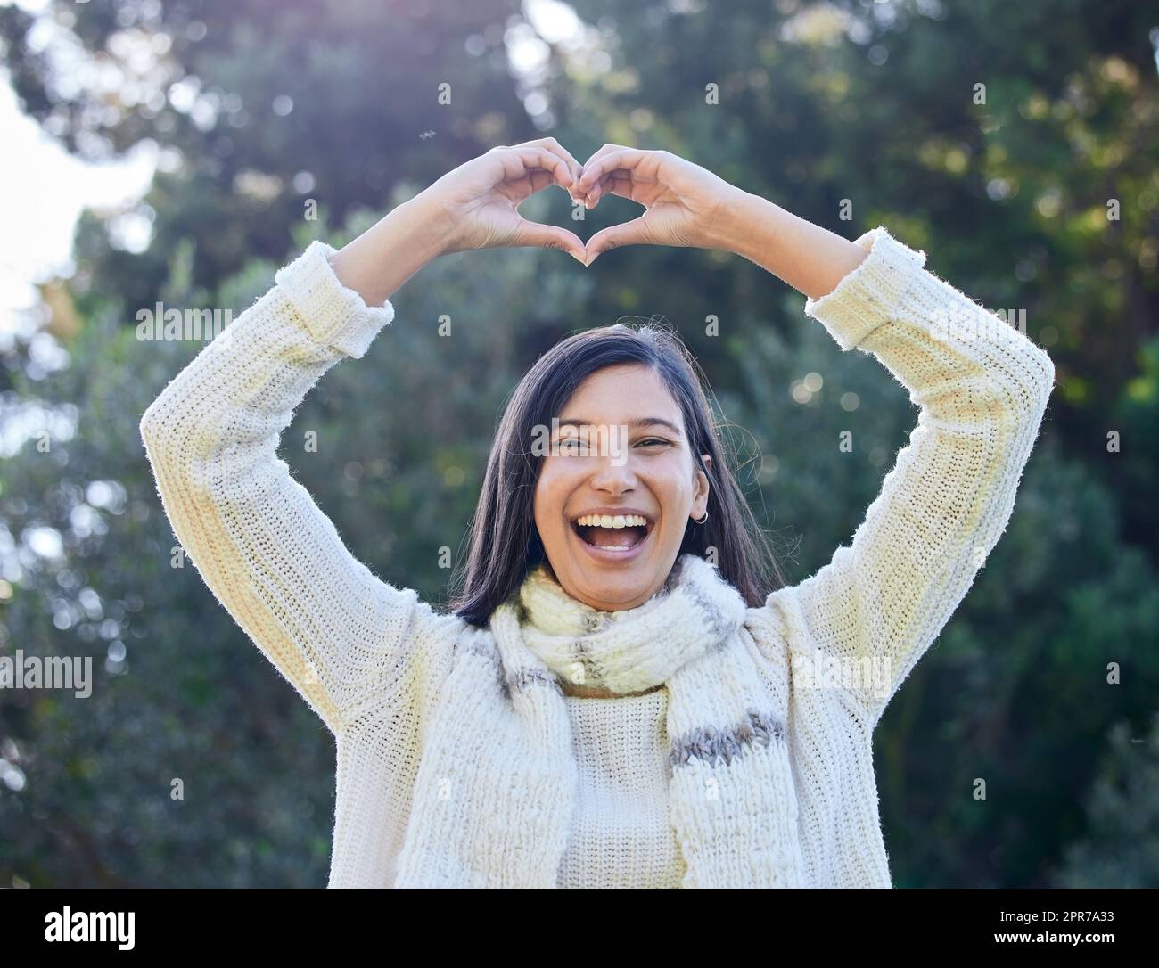 Youre that special one for me. a woman forming a heart shape with her hands above her head. Stock Photo