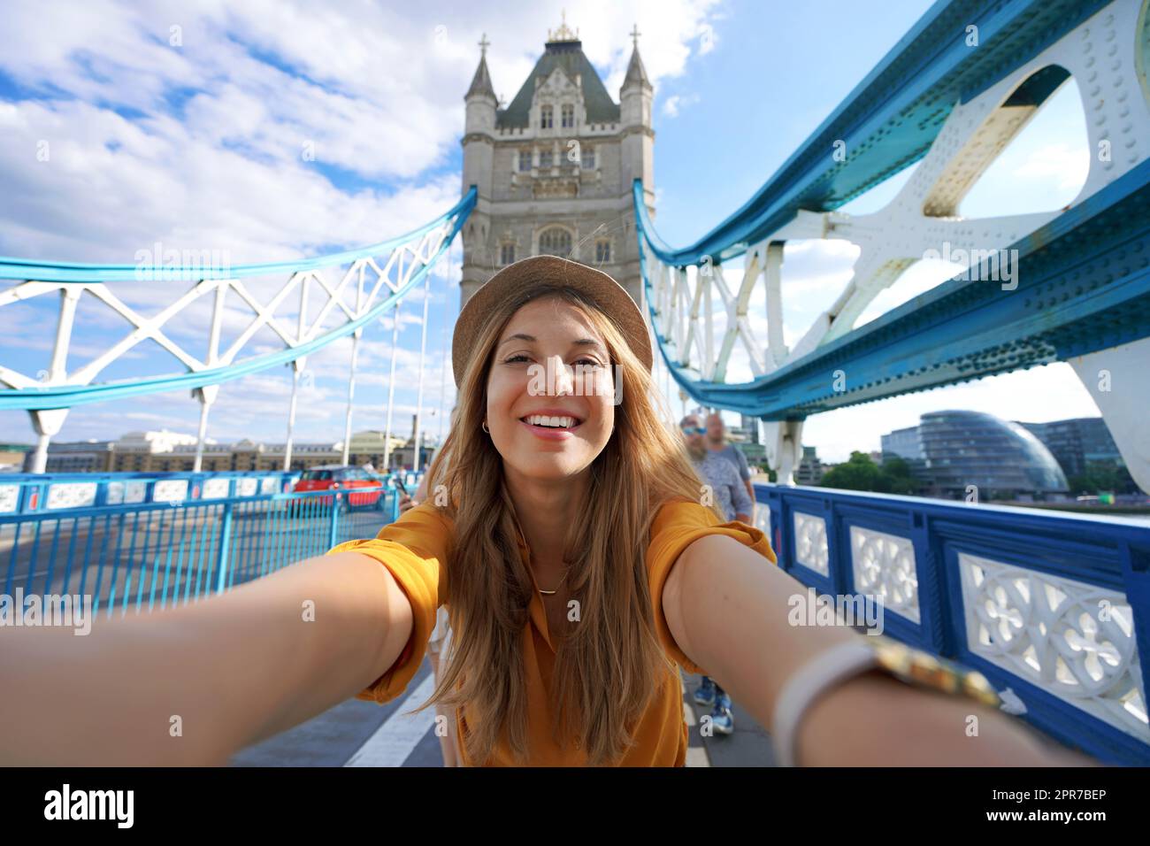Smiling girl takes selfie photo on Tower Bridge in London, United Kingdom Stock Photo