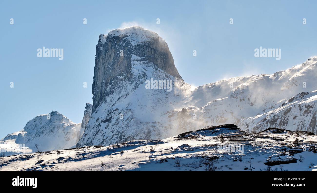 Mountain landscape with snow in the city of Bodoe and its surroundings in the North of the Polar Circle. Scenic view of glacier hills against a blue sky. Nature and natural landmark for tourism Stock Photo