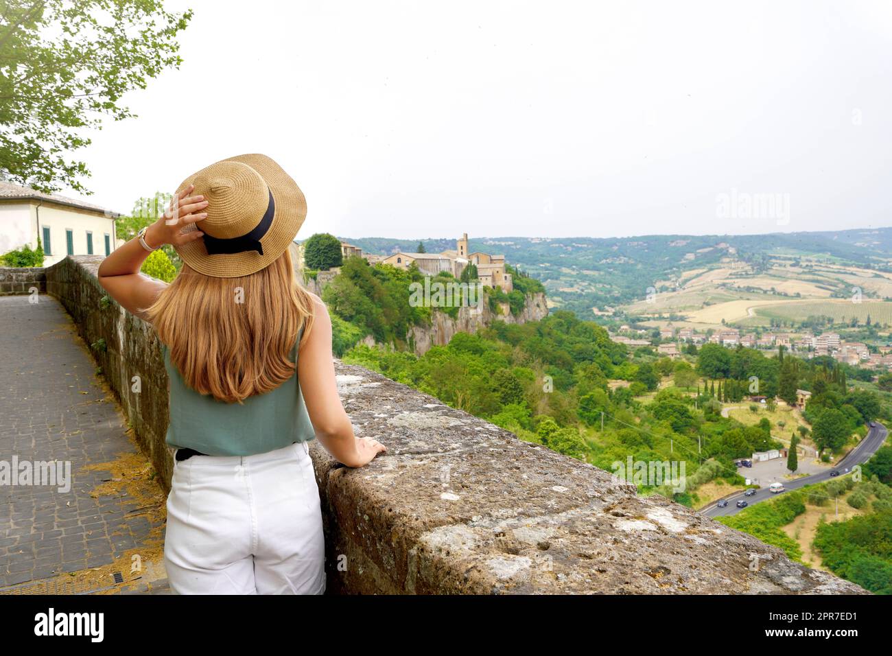 Young traveler woman walking in the peaceful town of Orvieto enjoying calm landscape of Umbria hills in central authentic Italy Stock Photo