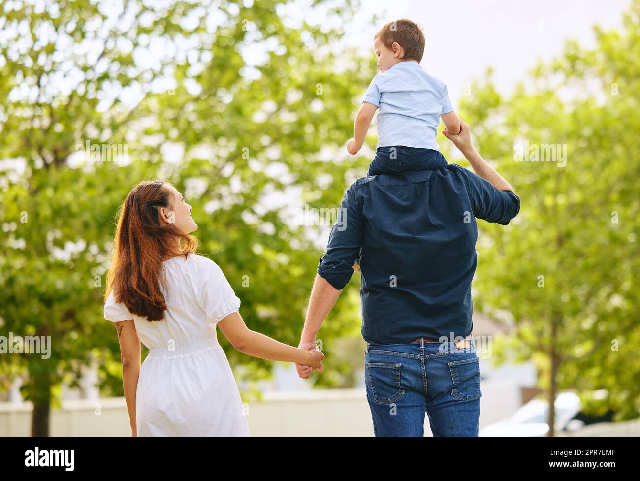 Walks with the family. Shot of a family taking a walk in the park. Stock Photo