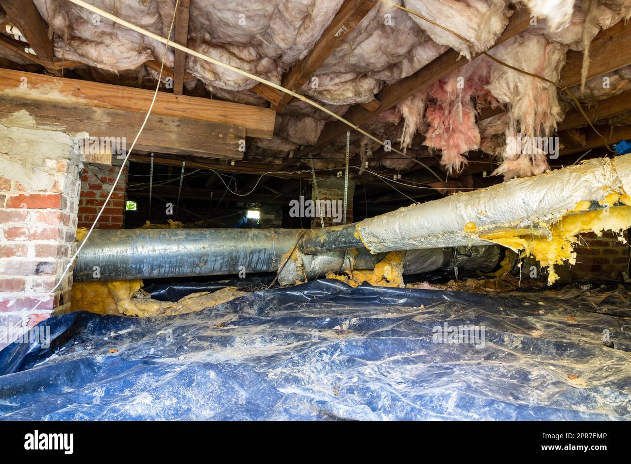 Old air conditioner duct work under house needing maintenance Stock Photo