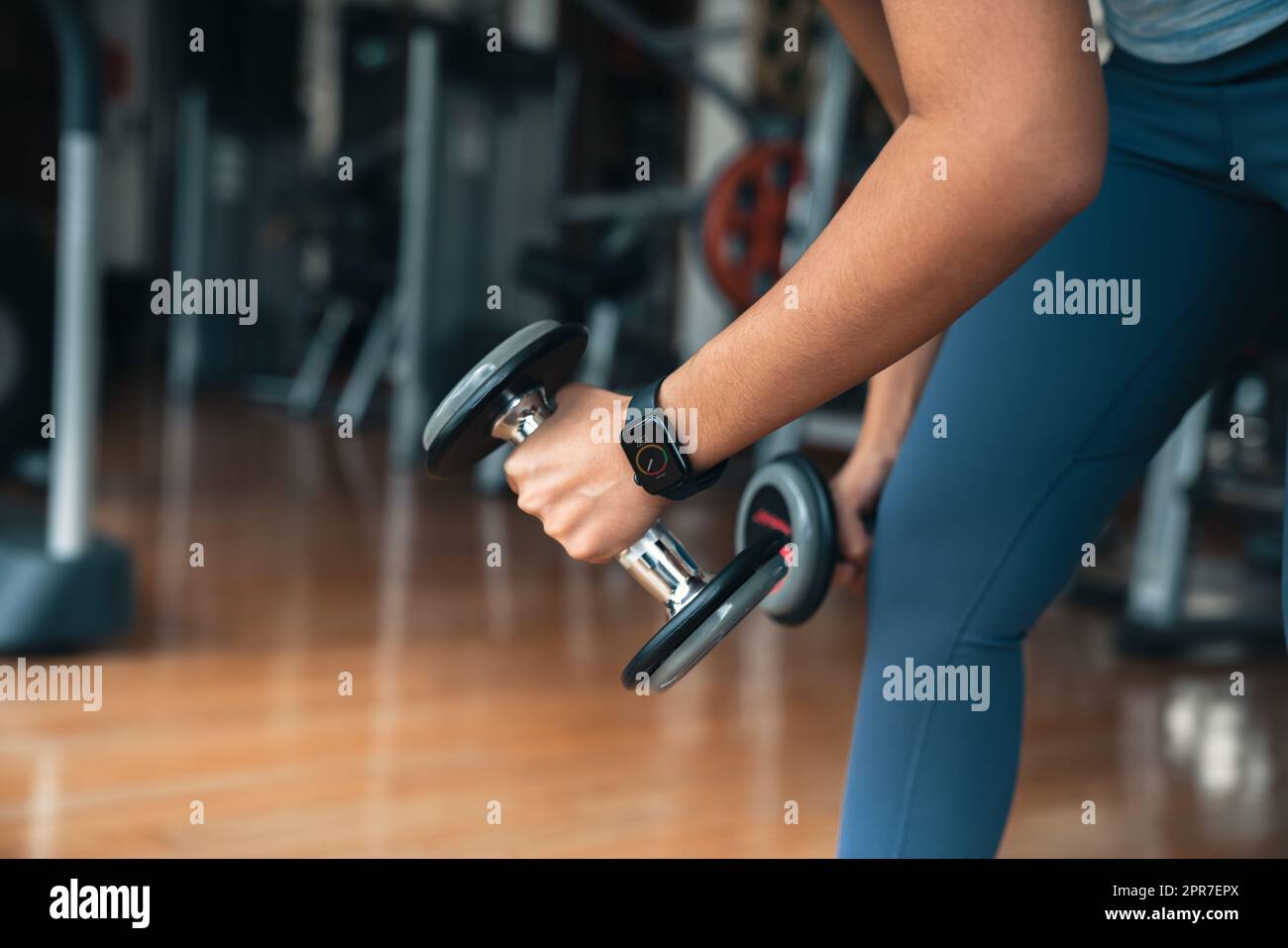 athlete woman lifting dumbbell, doing exercise at gym Stock Photo Alamy
