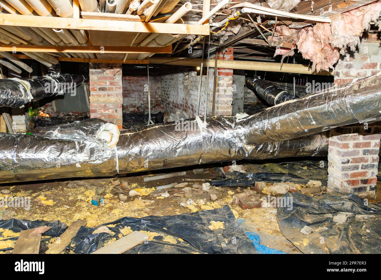 Air conditioner duct work under house in crawl space Stock Photo
