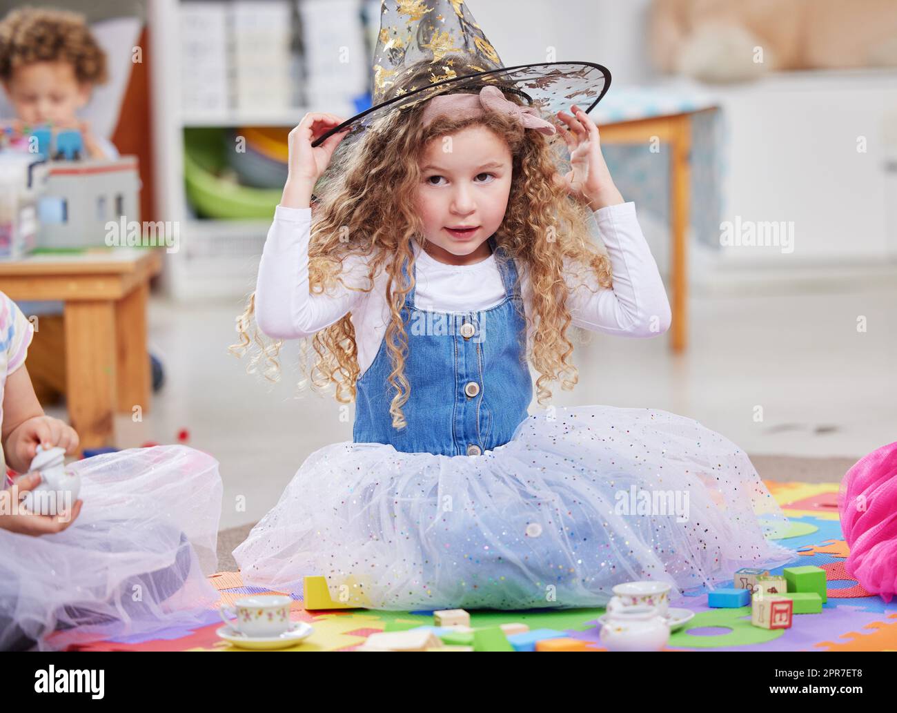 Dressing up is fun. Shot of a little girl playing dress-up in class. Stock Photo