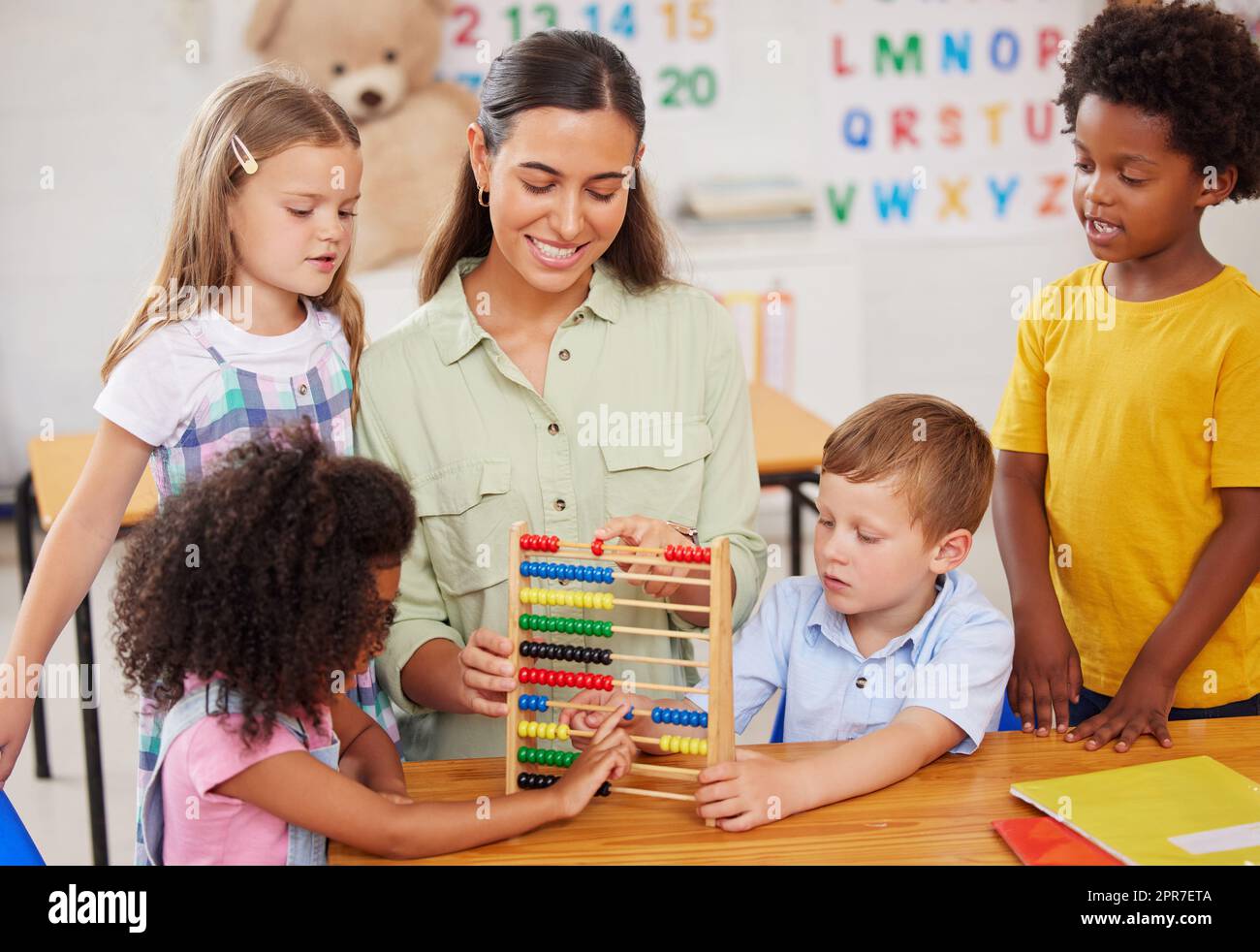 Freedom of play gives children the chance to expand their curiosity. Shot of a young woman teaching a class of preschool children. Stock Photo