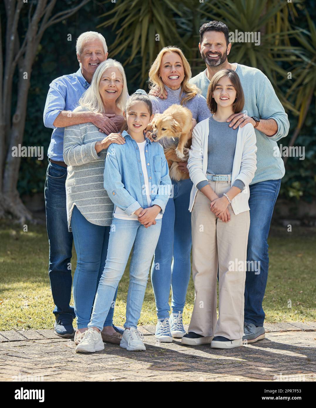 Family brings hardship. But it also brings much joy. Shot of a multi-generational family standing together outside. Stock Photo