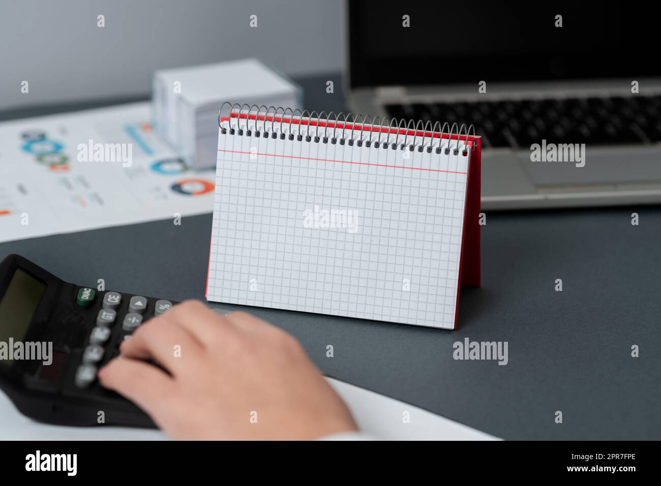 Blank Opened Spiral Notebook With A Calculator And A Pen Placed Over A Table. Empty Lined Notepad And Pencil On Top Of A Desk With A Calculation Device. Stock Photo