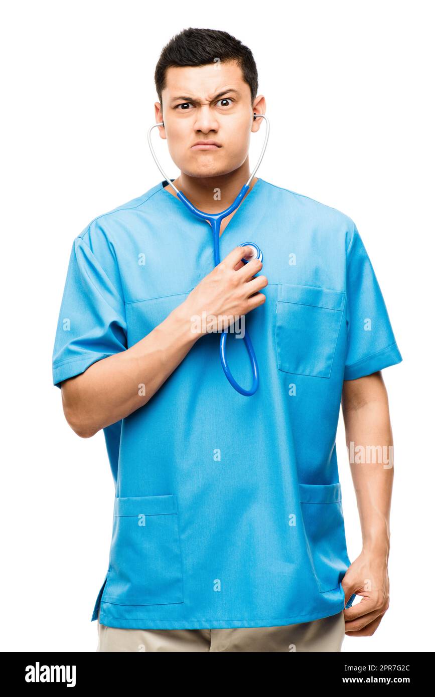 Been feeling off kilter lately. Shot of a young male nurse using his stethoscope against a studio background. Stock Photo
