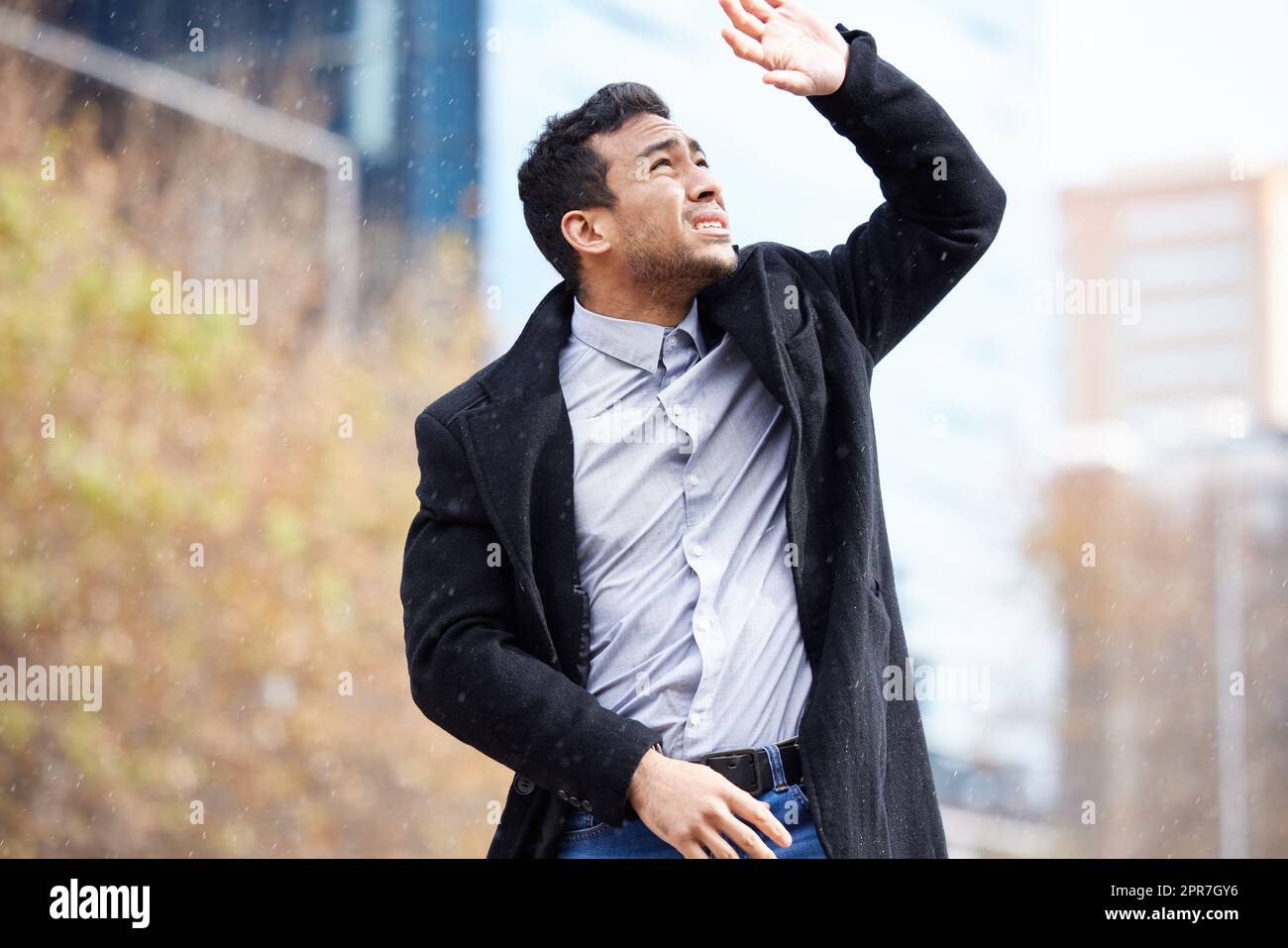 I didnt think it was gonna rain today. a handsome young businessman