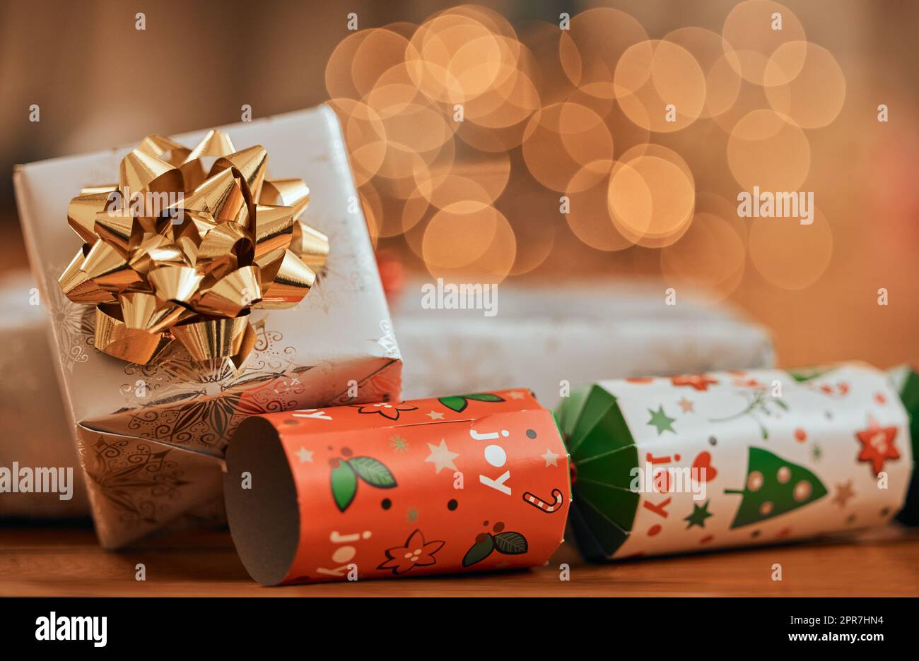The season where joy is in abundance. Closeup shot of a gift box and a cracker during Christmas. Stock Photo