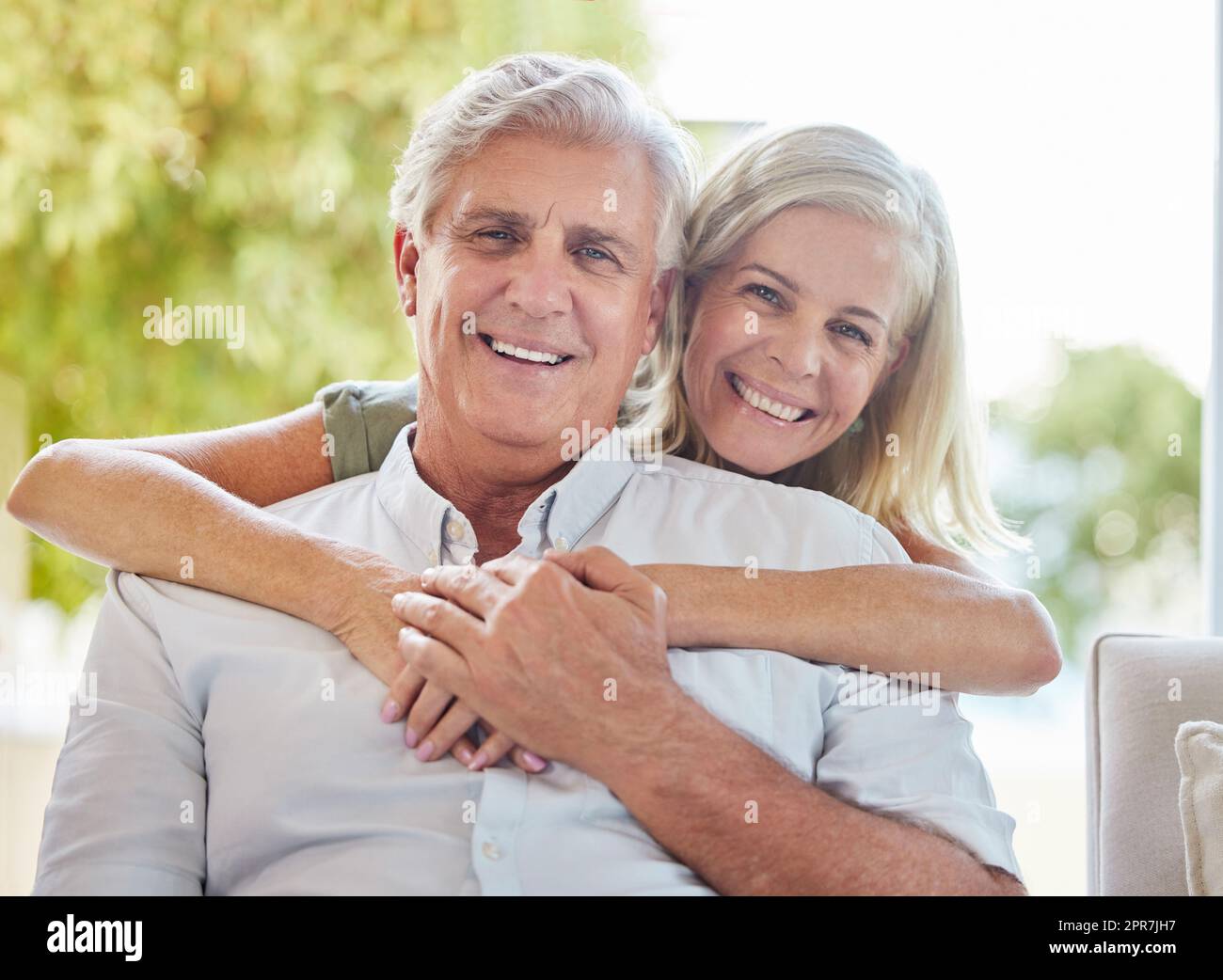 A happy mature caucasian couple embracing and showing love while