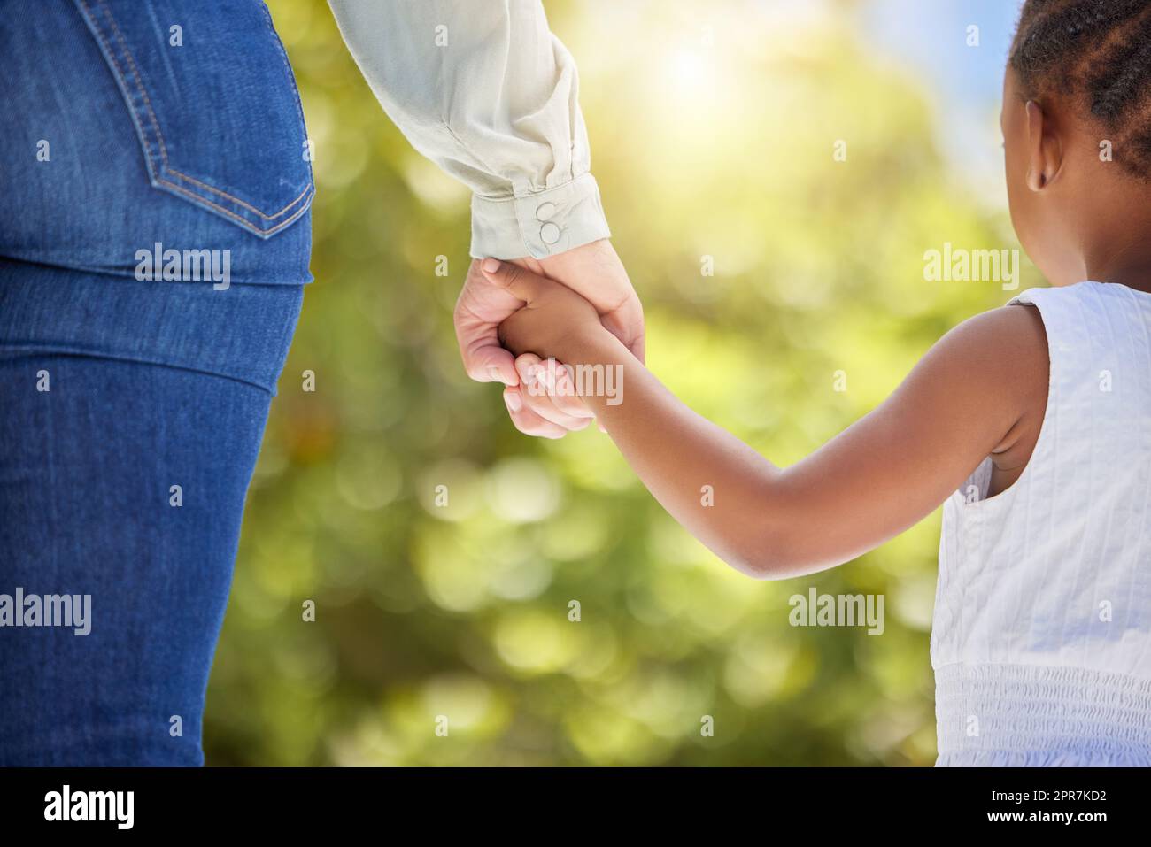 Lets go for a walk. an unrecognizable child and parent holding hands in nature. Stock Photo