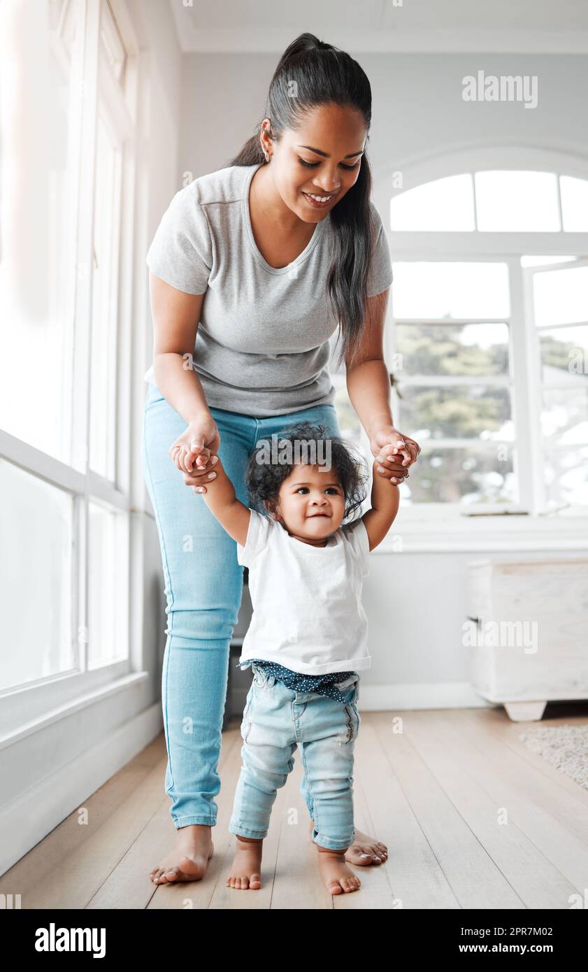 The pitter patter of tiny feet. a little girl learning to walk with the